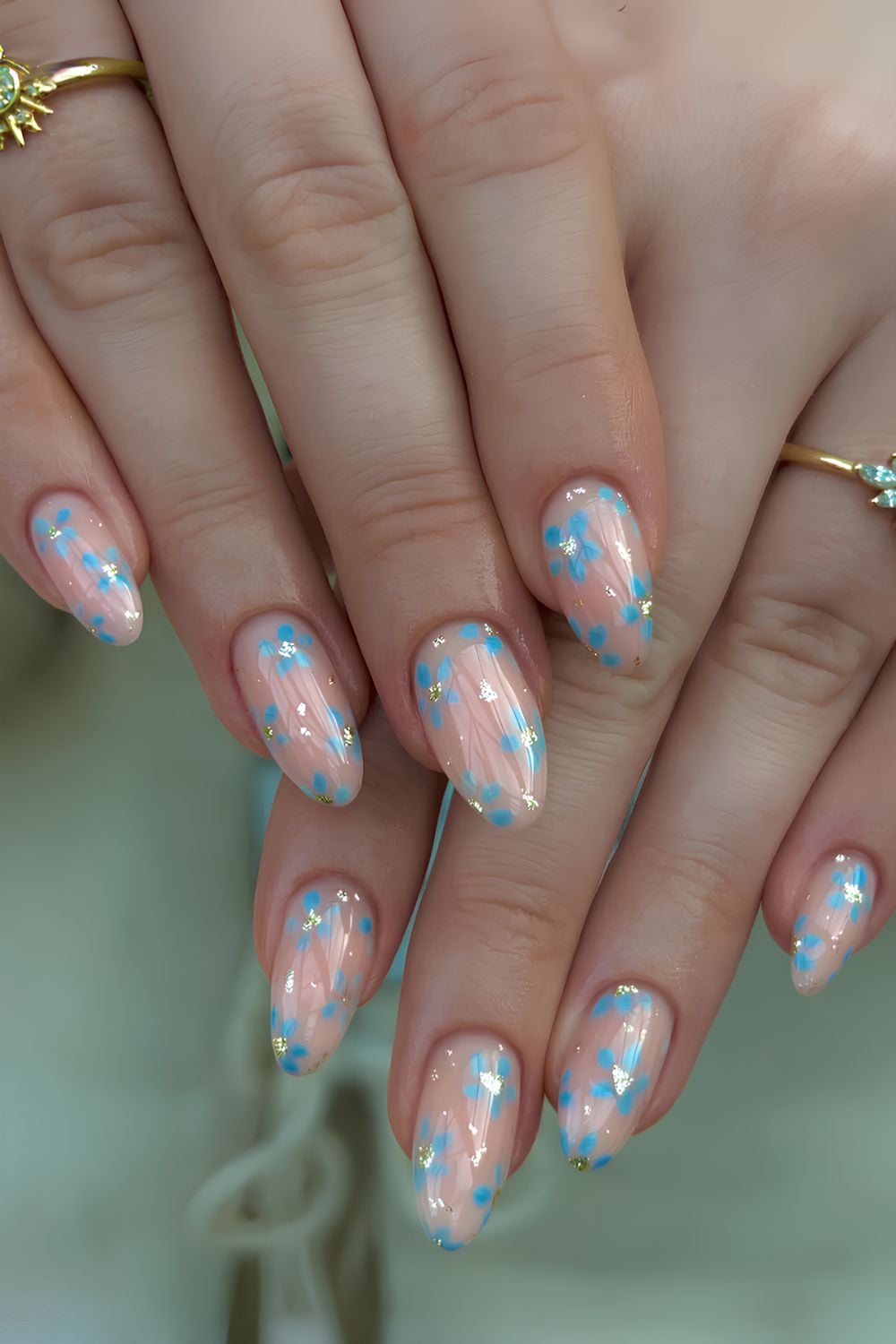 Sheer and glossy nails with blue flowers