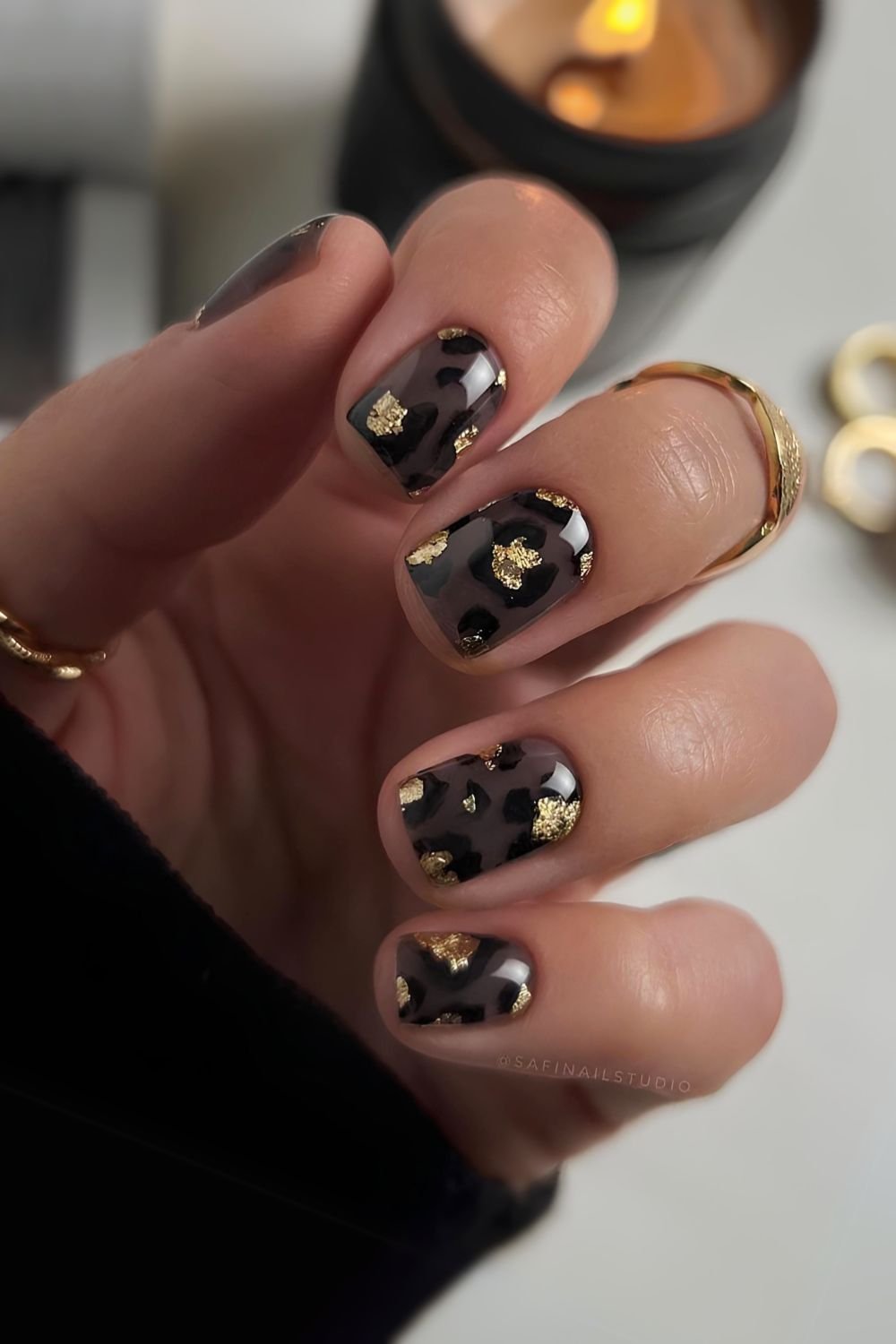 Sheer black nails with gold and leopard print accents