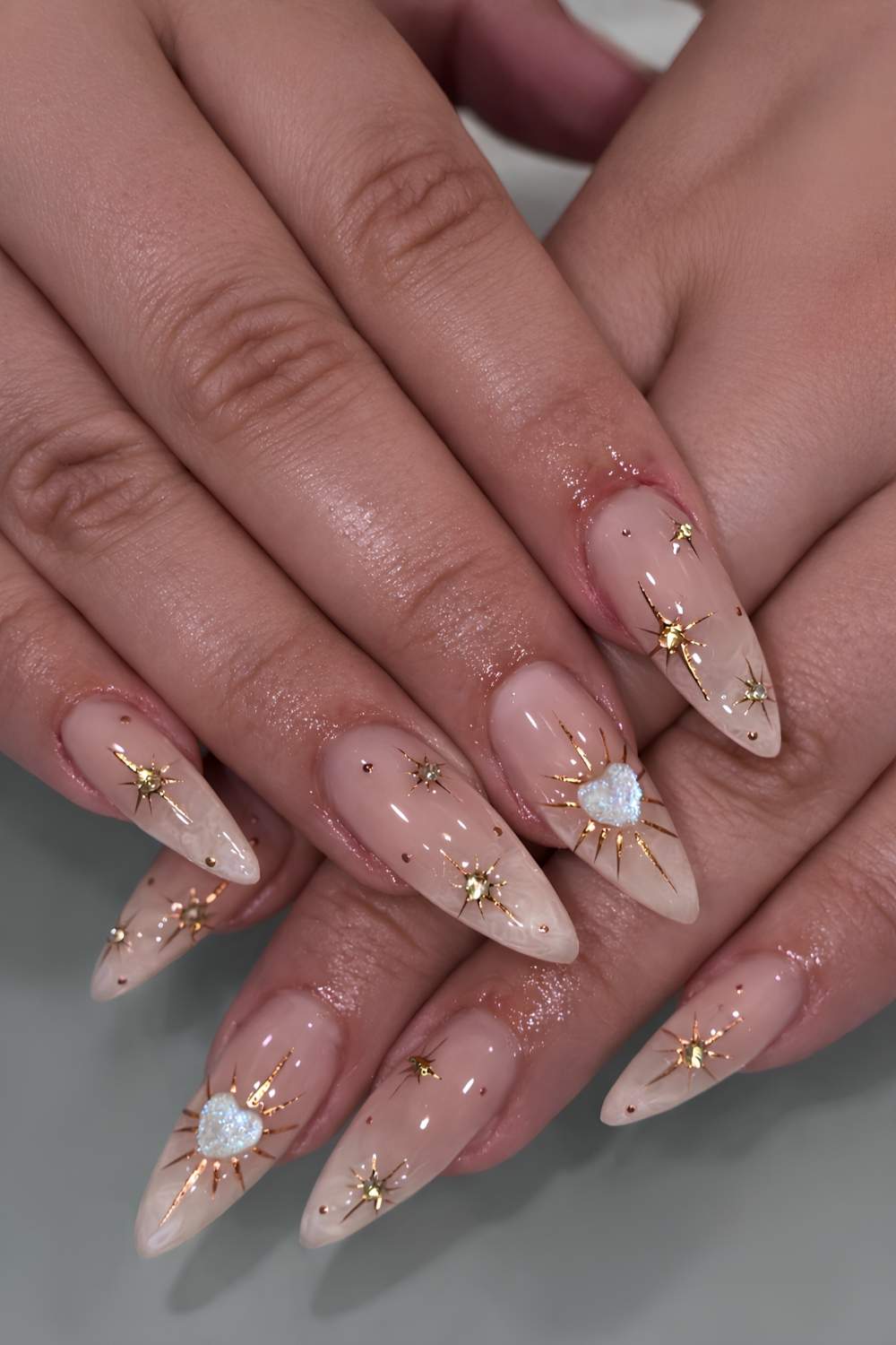 Sheer nails with gold celestial art and gems