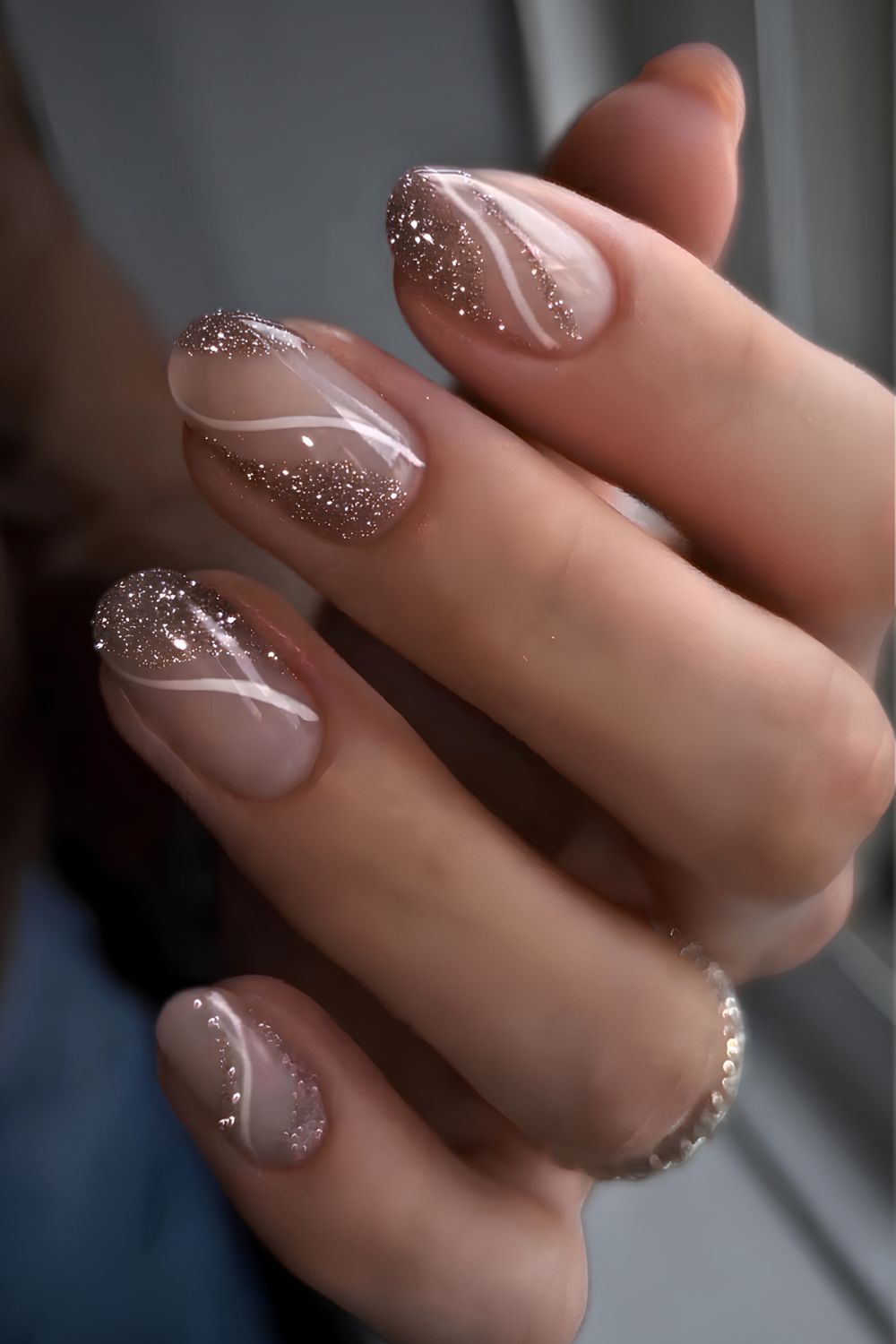 Sheer nails with negative space gold glitter accents