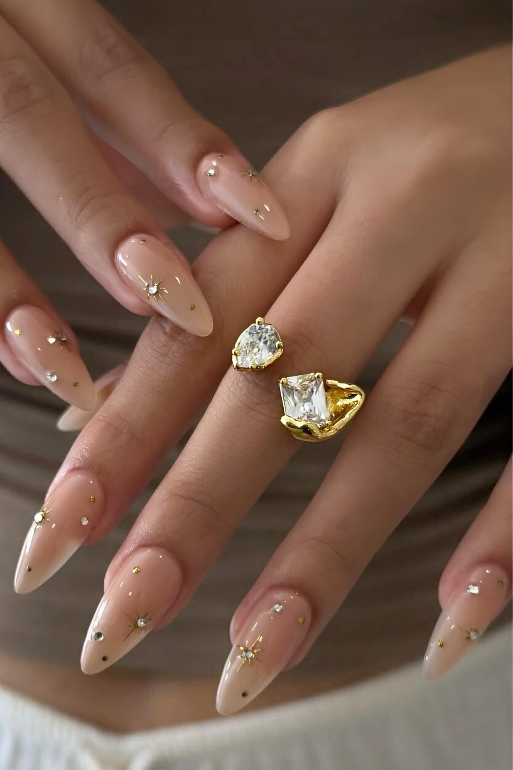 Sheer neutral nails with celestial art