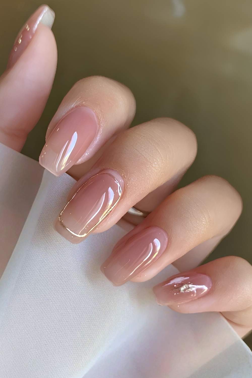 Sheer pink nails with gold accents