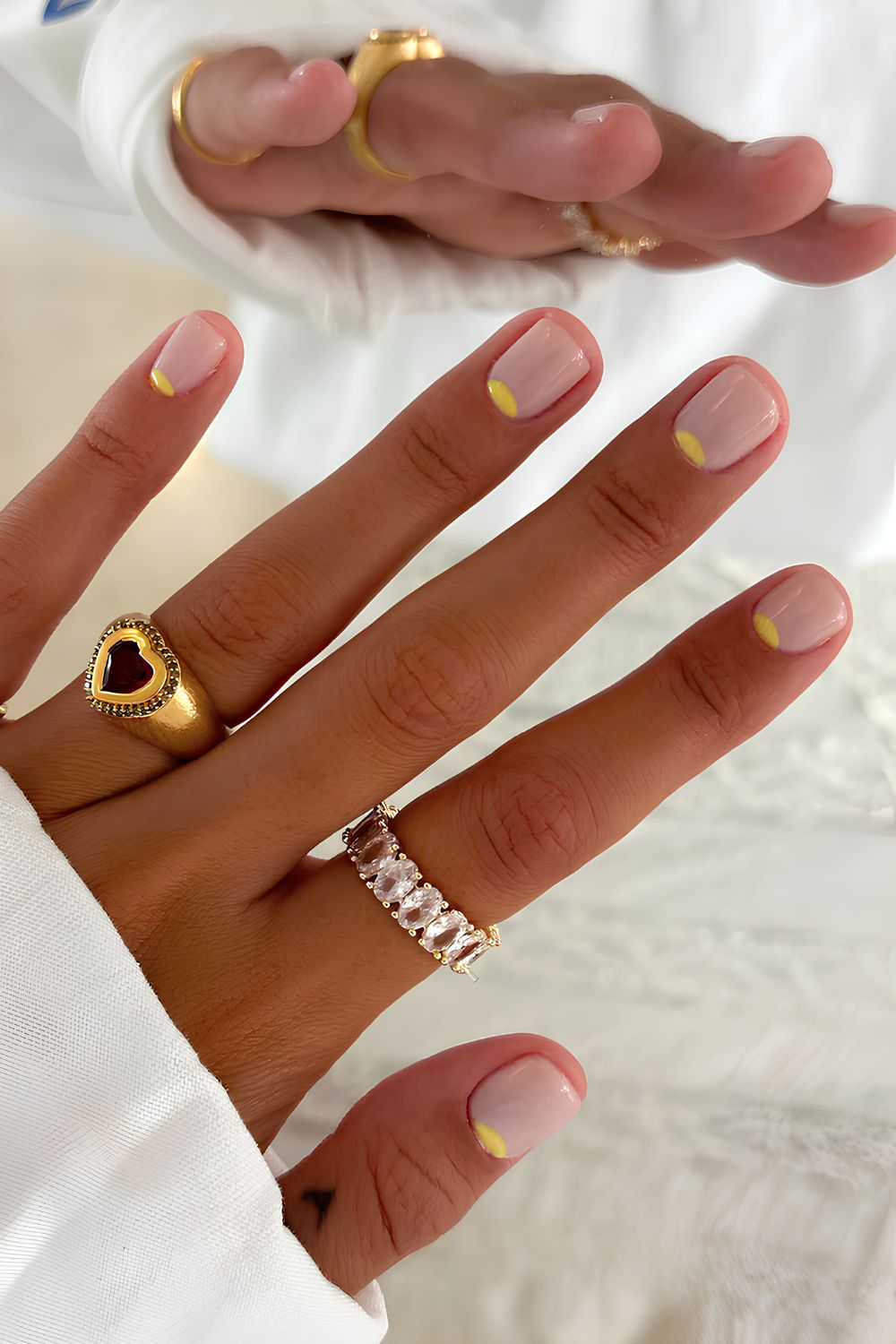 Sheer white mani with yellow half-moon details