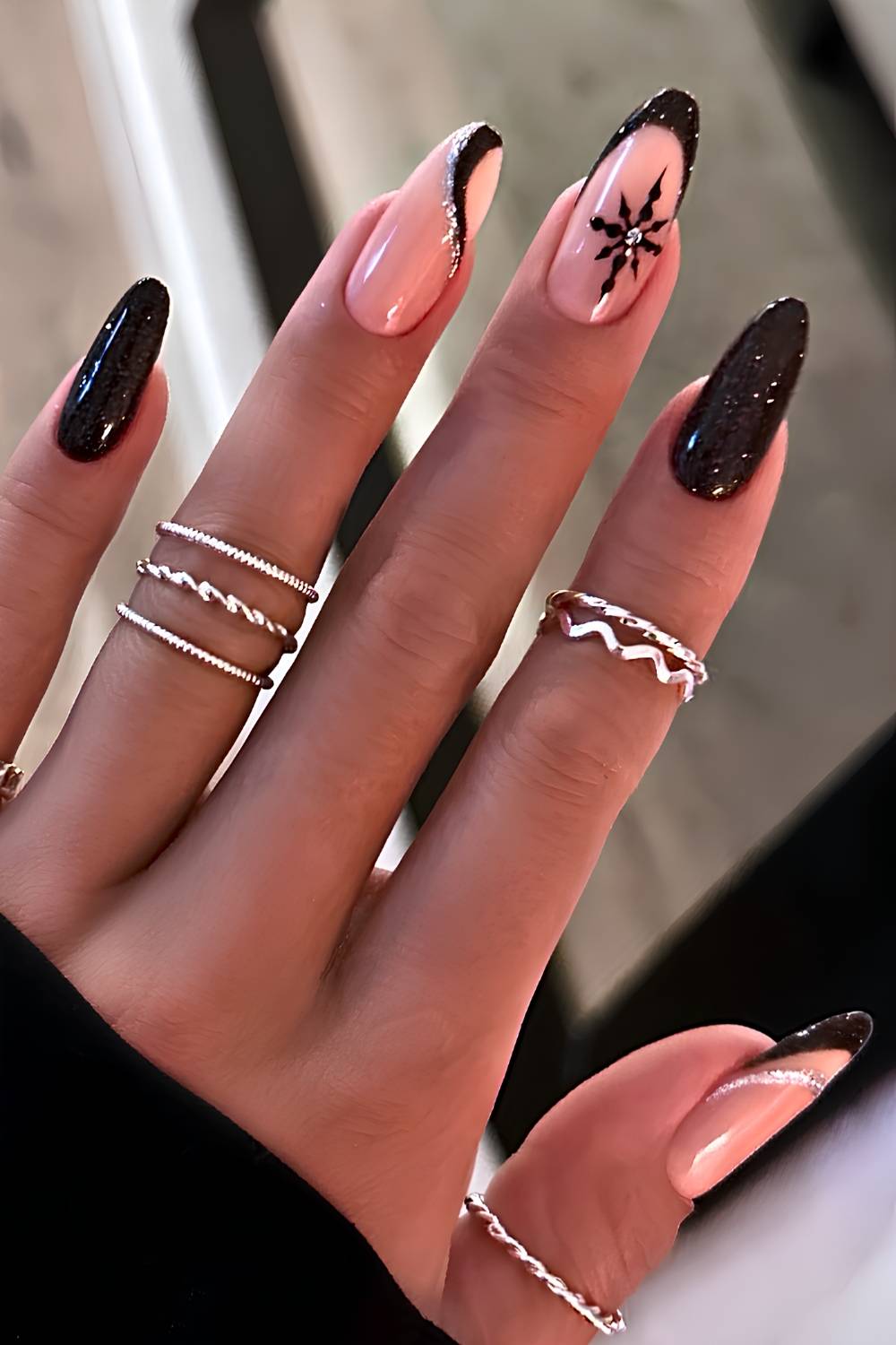Shimmery black mani with snowflakes and swirls