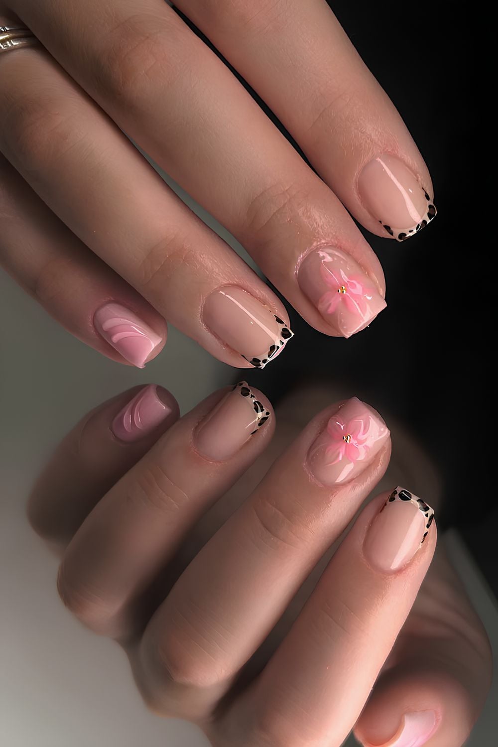 Short animal print nails with floral accents