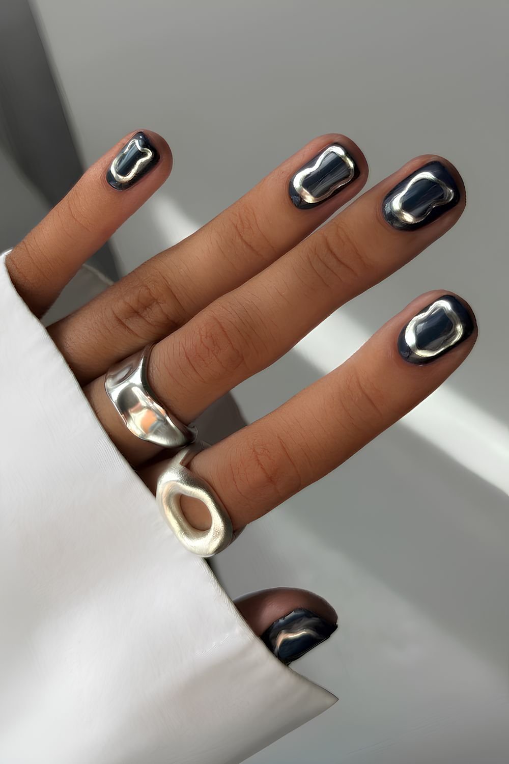 Short black nails with silver chrome details