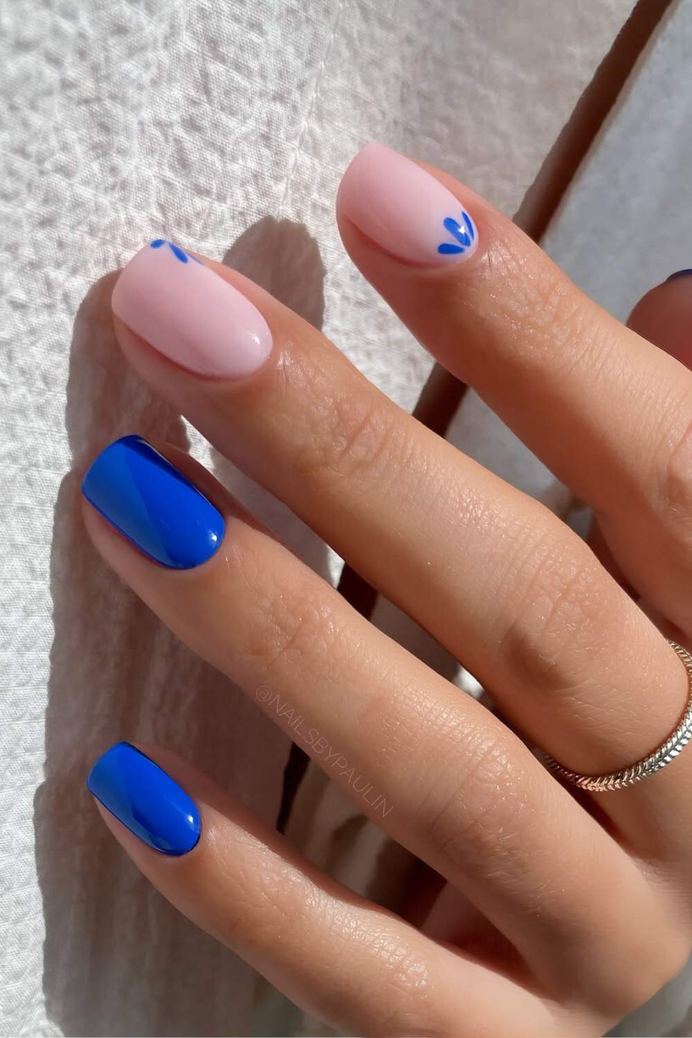 Short cobalt blue mani with ceramic-inspired flowers