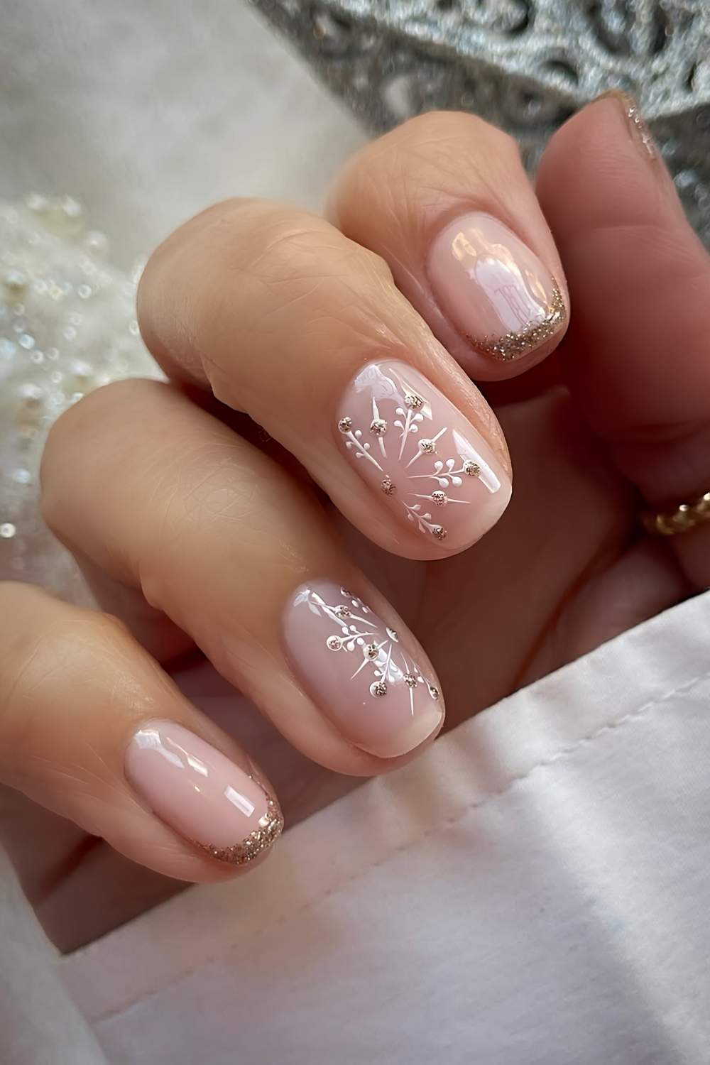Short gold glitter French mani with snowflakes