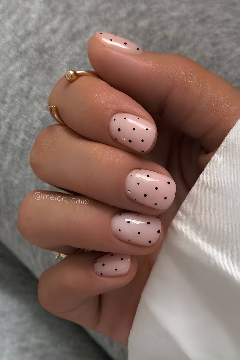 Short milky white nails with black polka dots