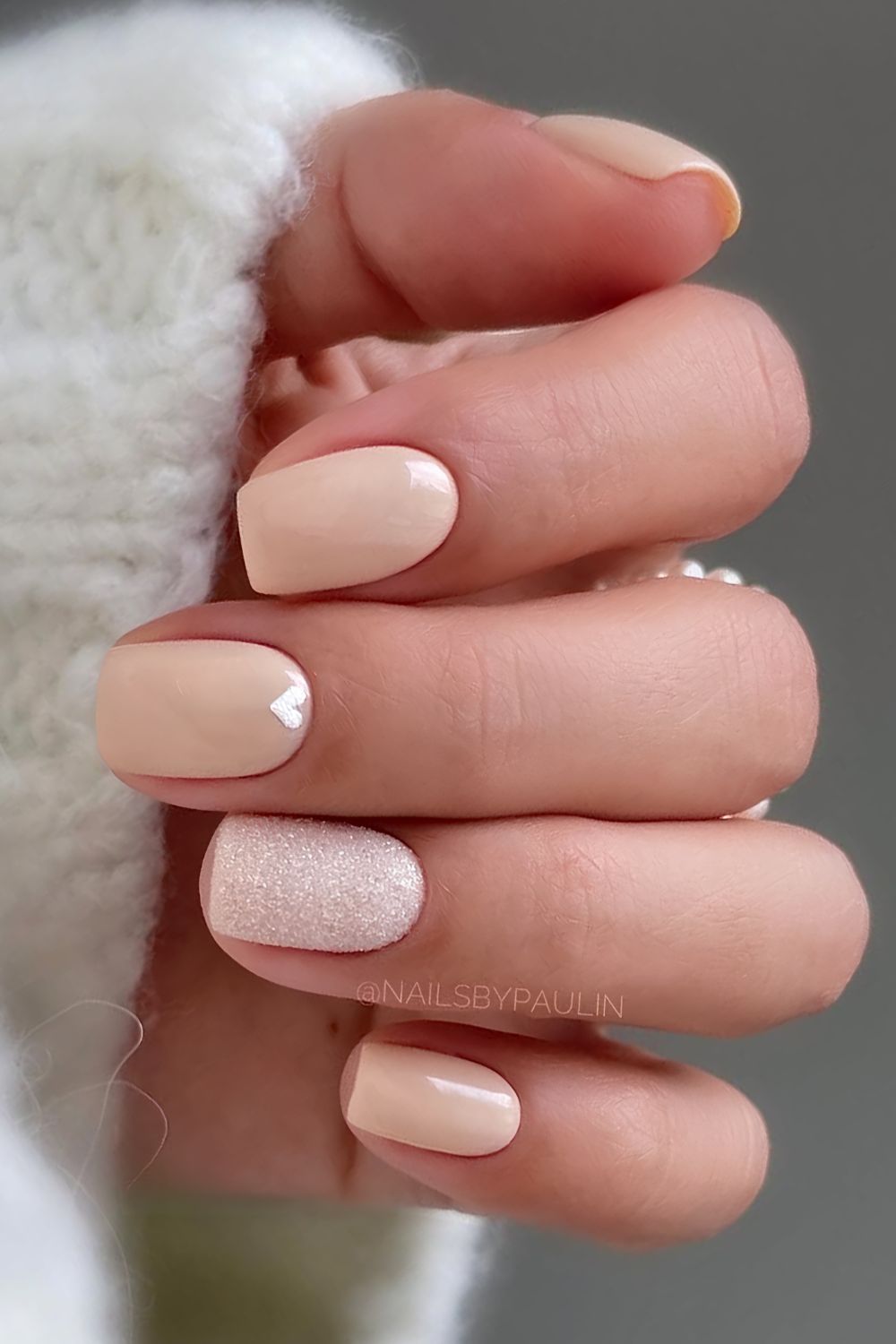 Short neutral nails with hearts and glitter