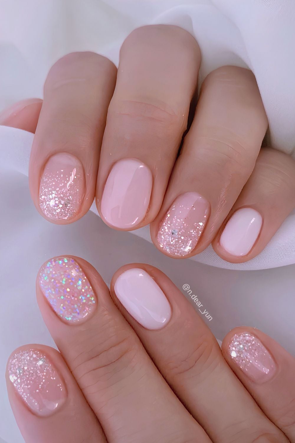 Short pink manicure with glitter