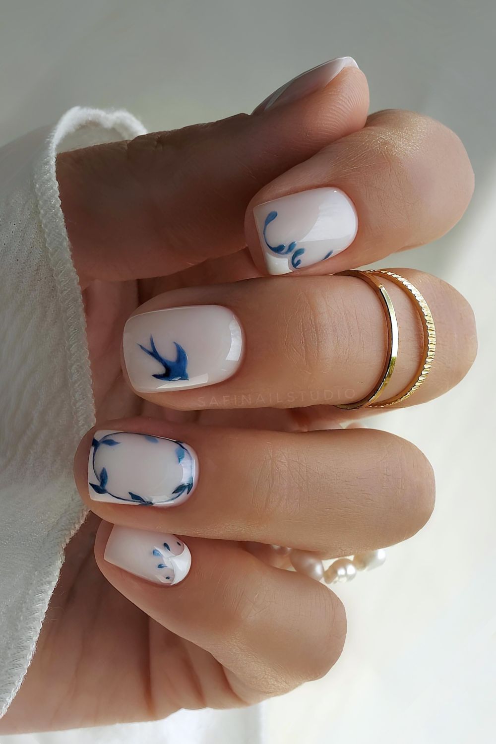 Short porcelain nails in white and blue