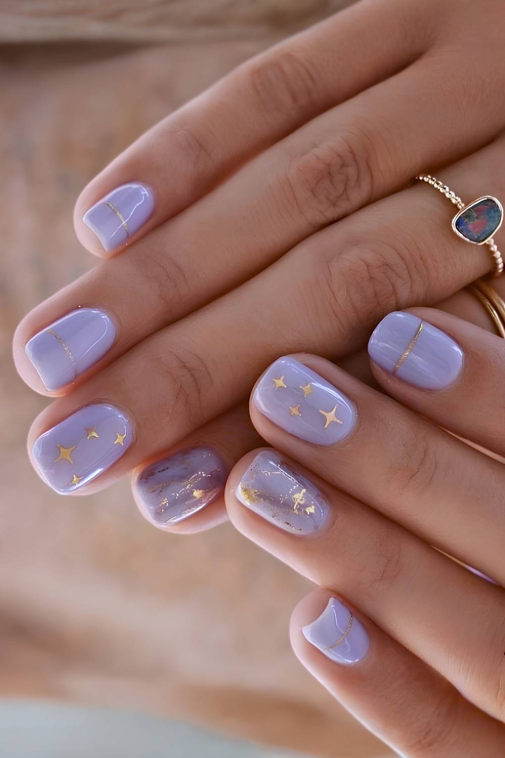 Short purple nails with gold stars
