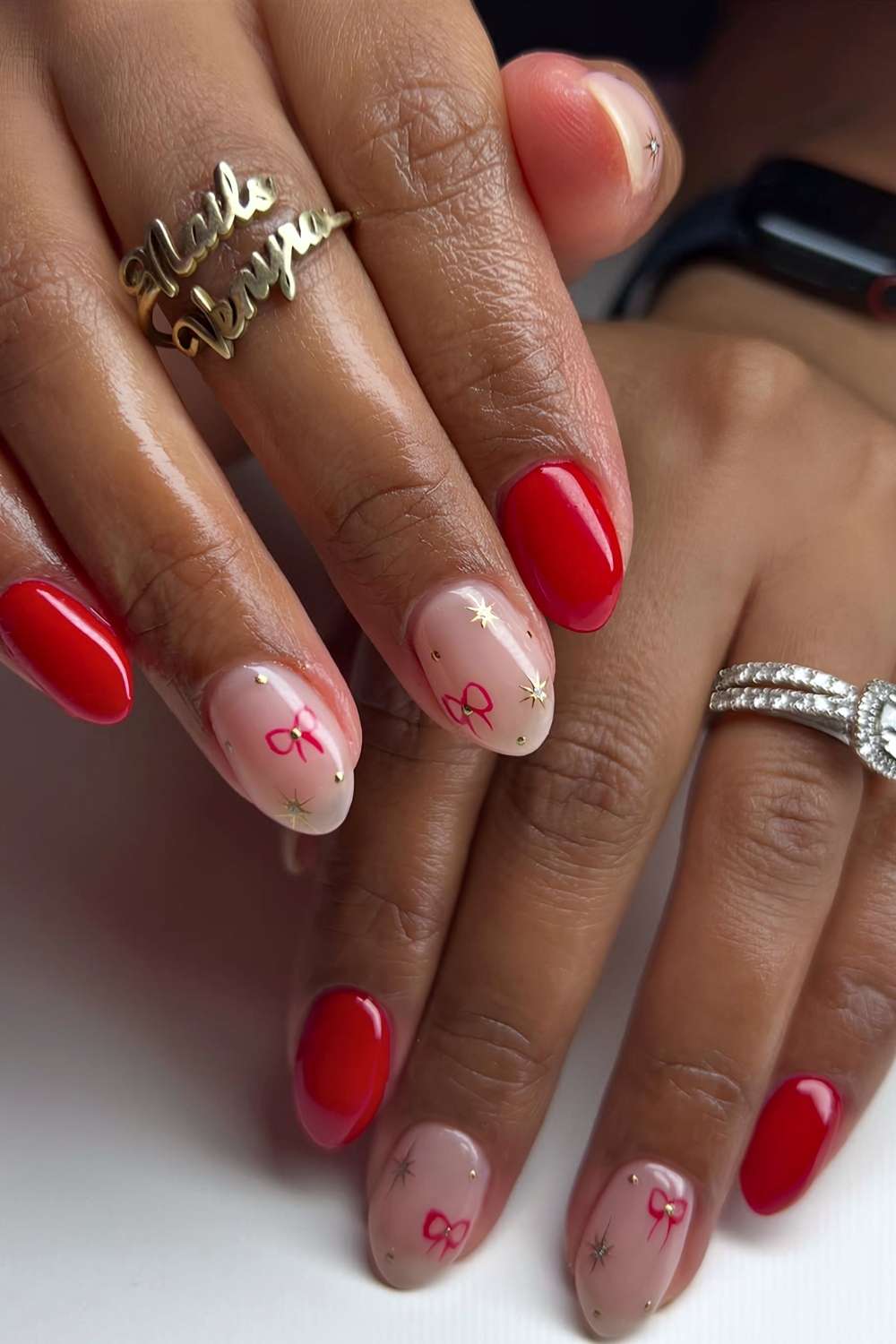 Short red nails with micro stars and bows