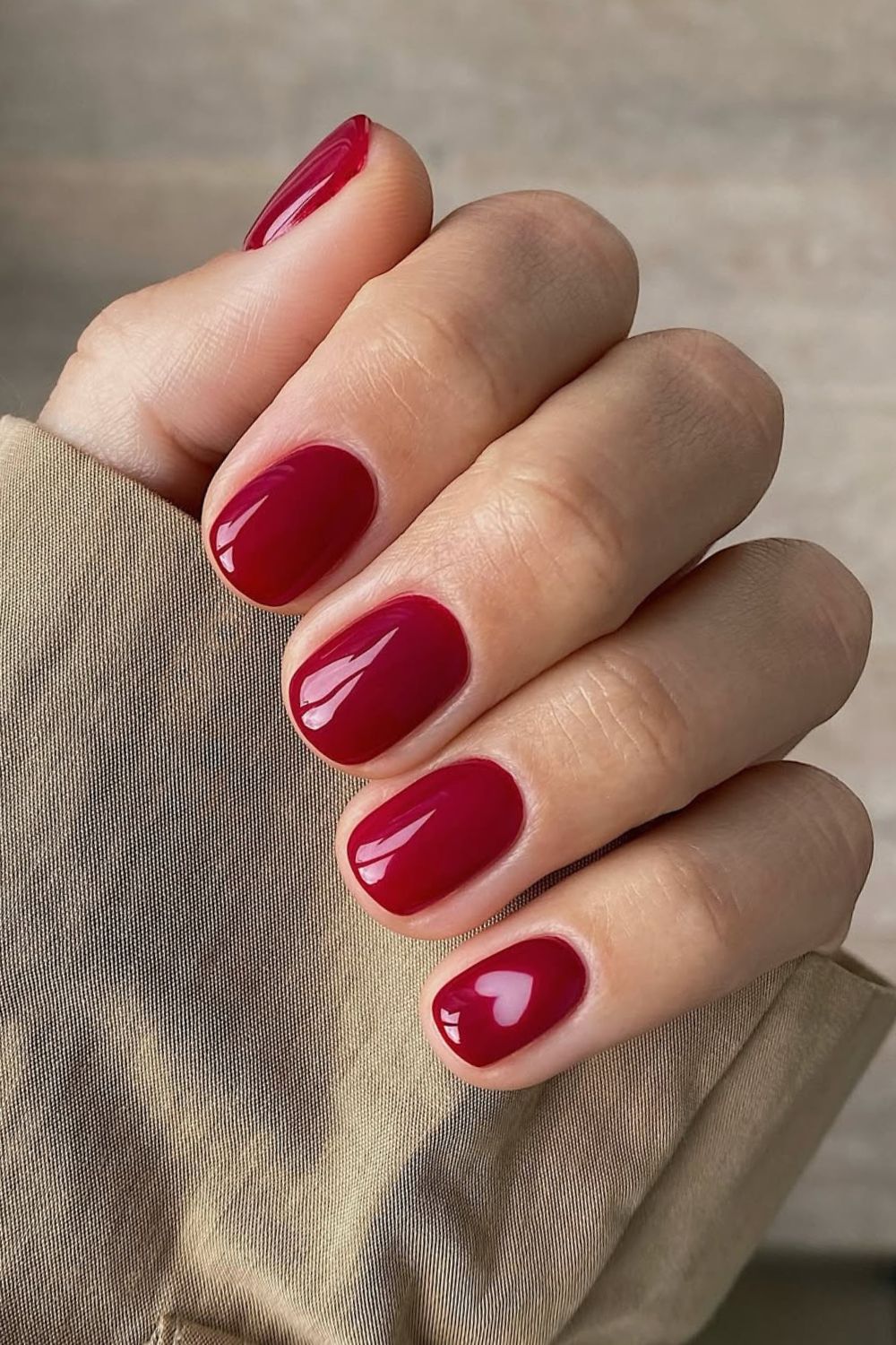 Short red nails with negative space heart accent