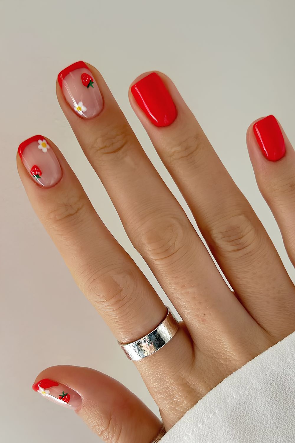 Short red nails with strawberries and flowers