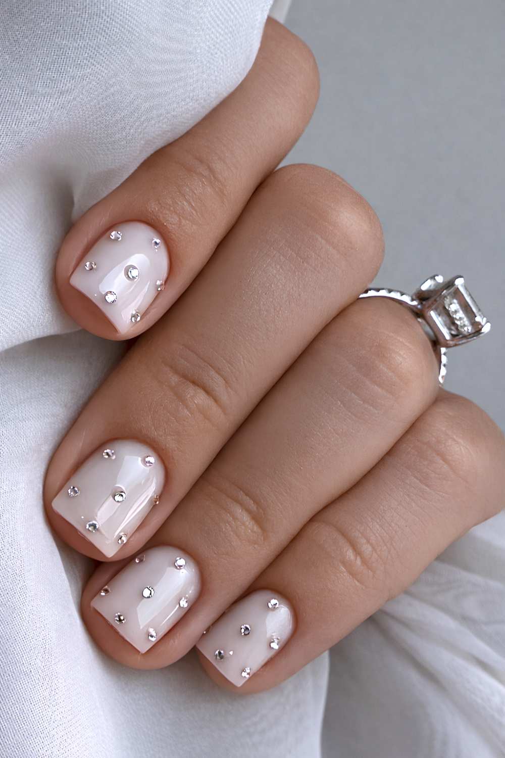 Short white bedazzled nails