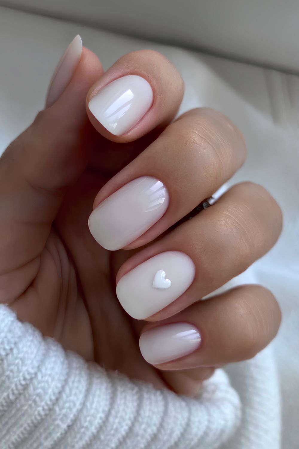 Short white mani with minimalist heart art