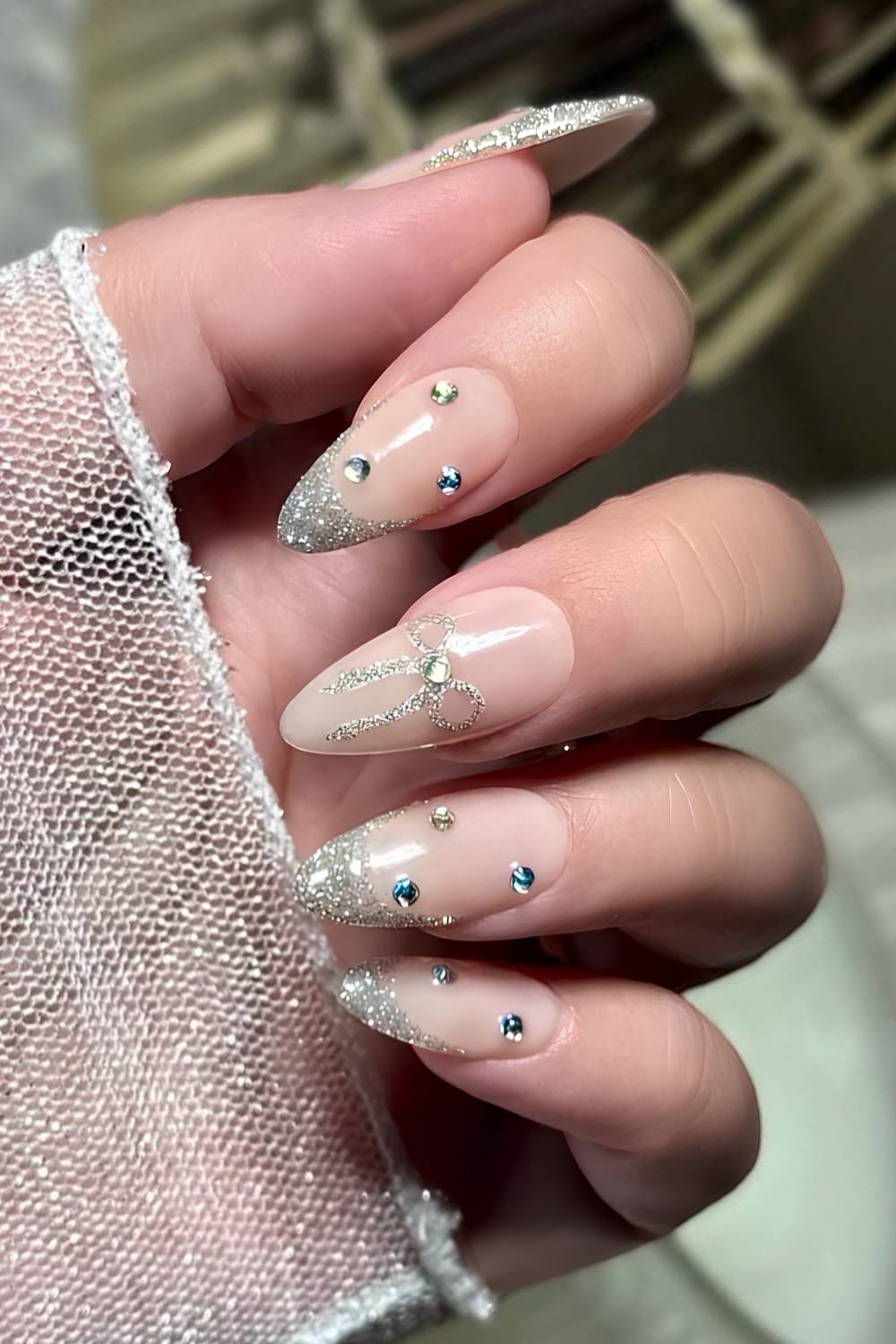 Silver glitter nails with coquette bows and gems