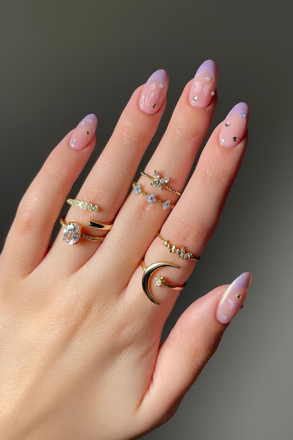 Soft lavender french tips with butterflies and gem designs