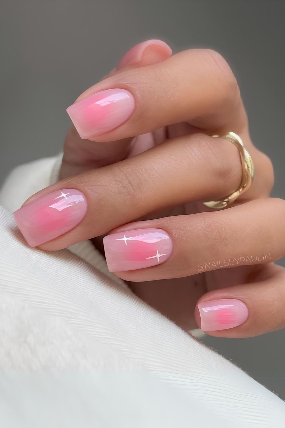 Soft pink aura nails with tiny stars