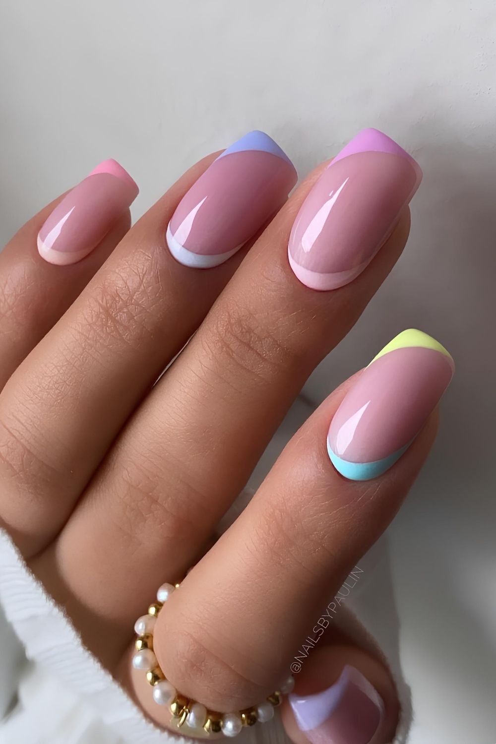 Soft pinky nails with reverse French tips in pastel colors