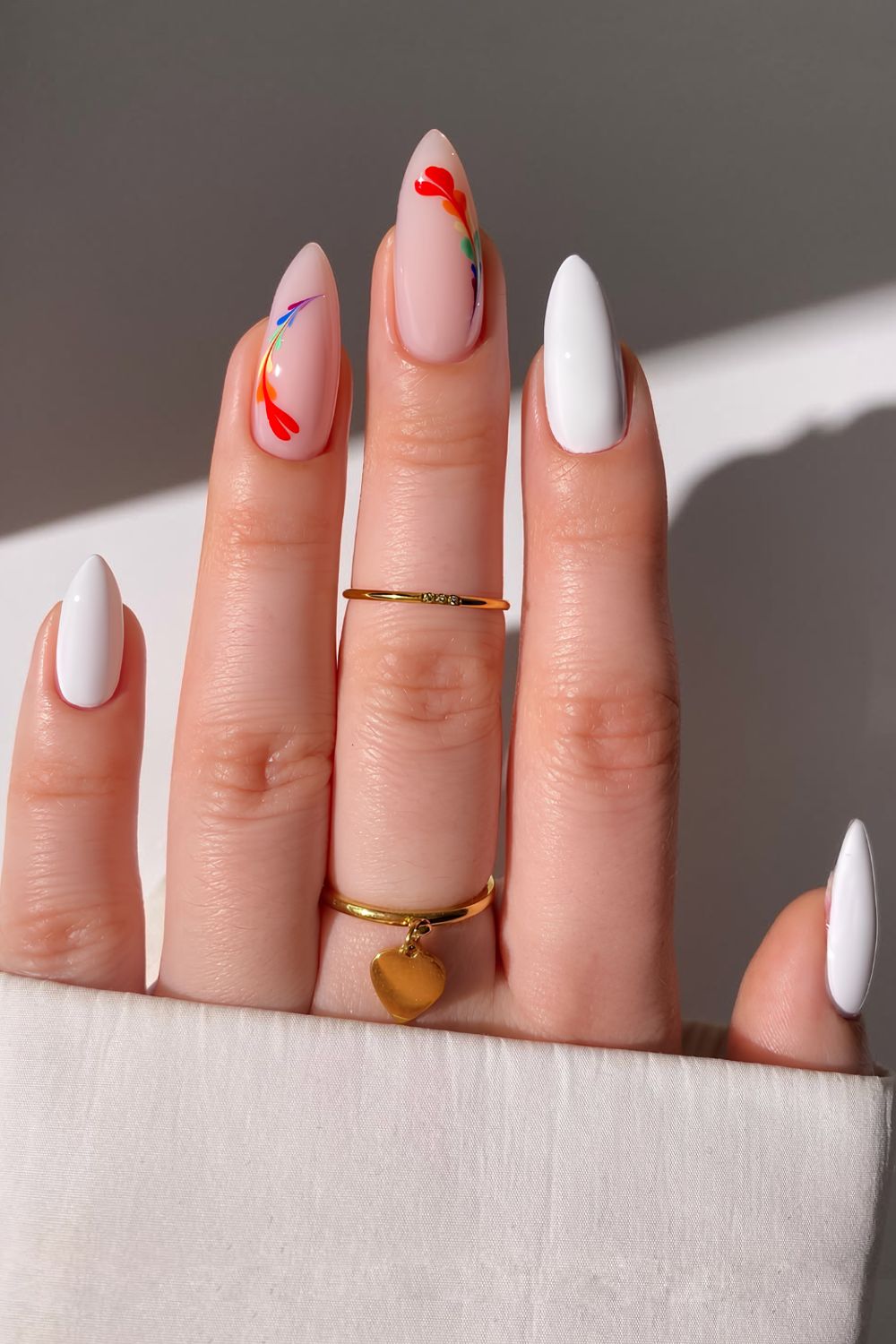 Solid white and milky white wit drag-marble hearts in pride colors