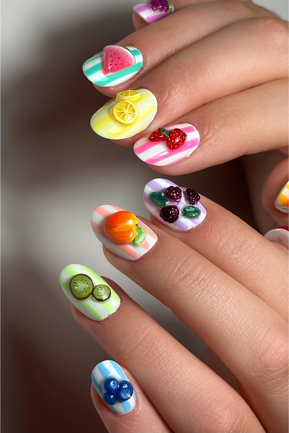 Striped colorful nails with 3d fruit accents