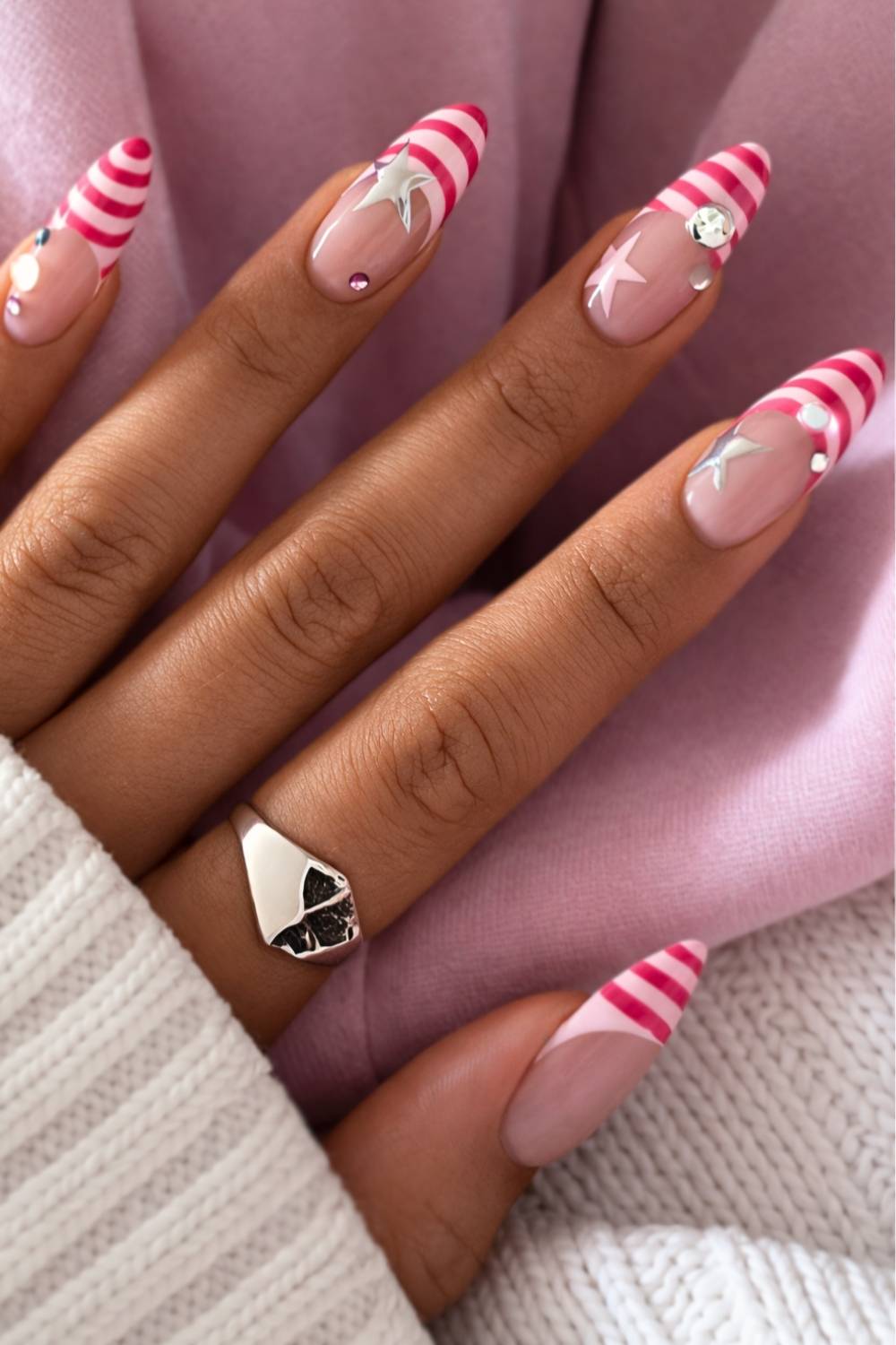 Striped pink French nails with stars and gems