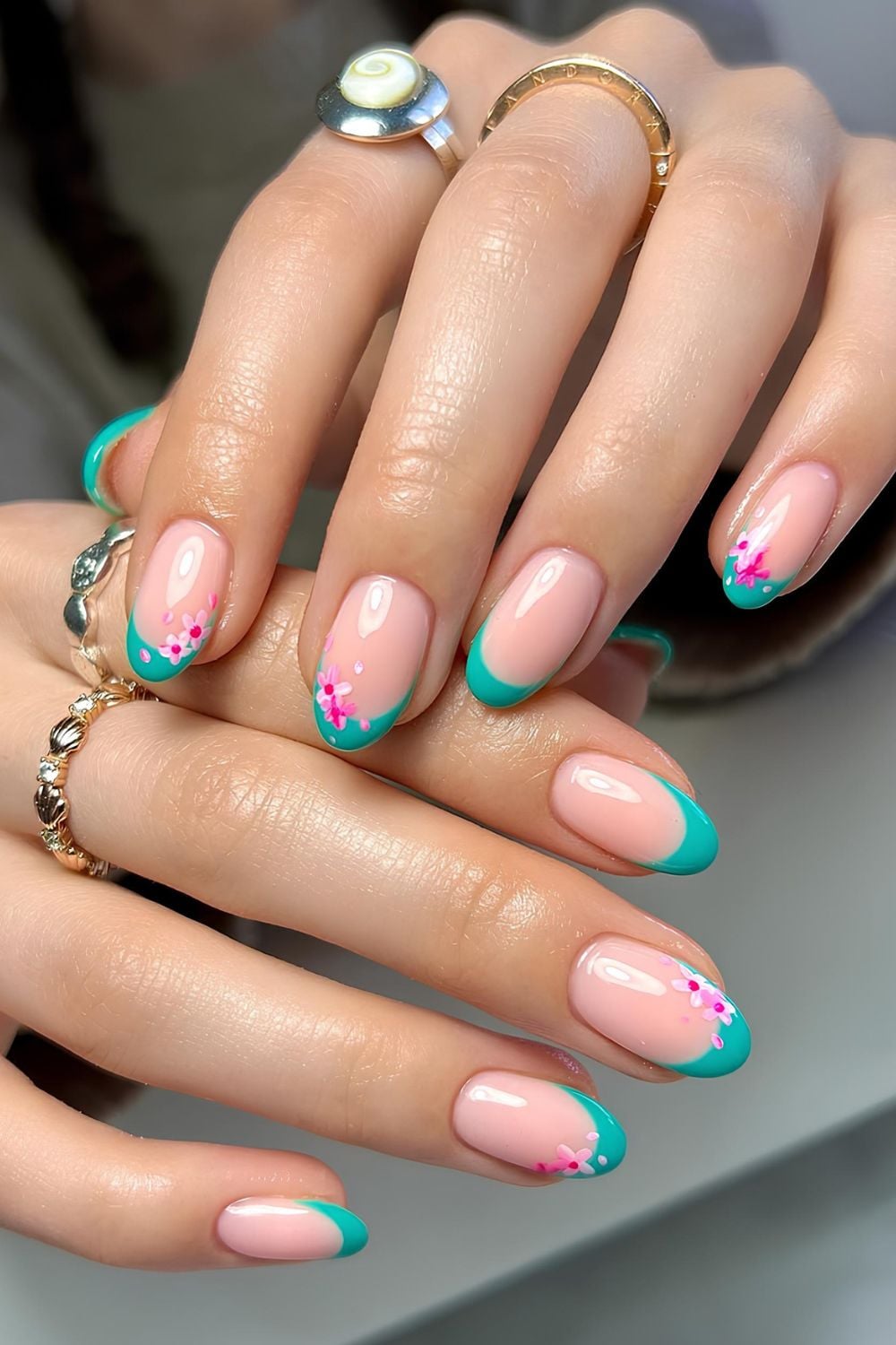 Teal French nails with cherry blossoms