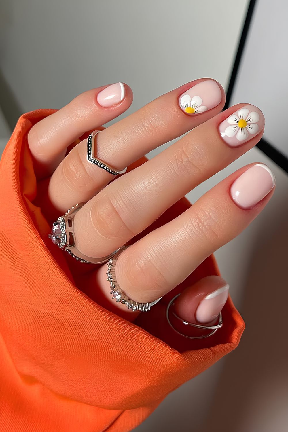 Thin white French nails with daisies