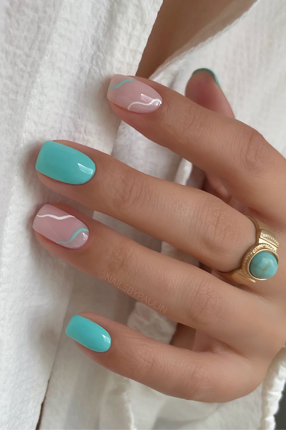 Turquoise and milky white nails with swirls