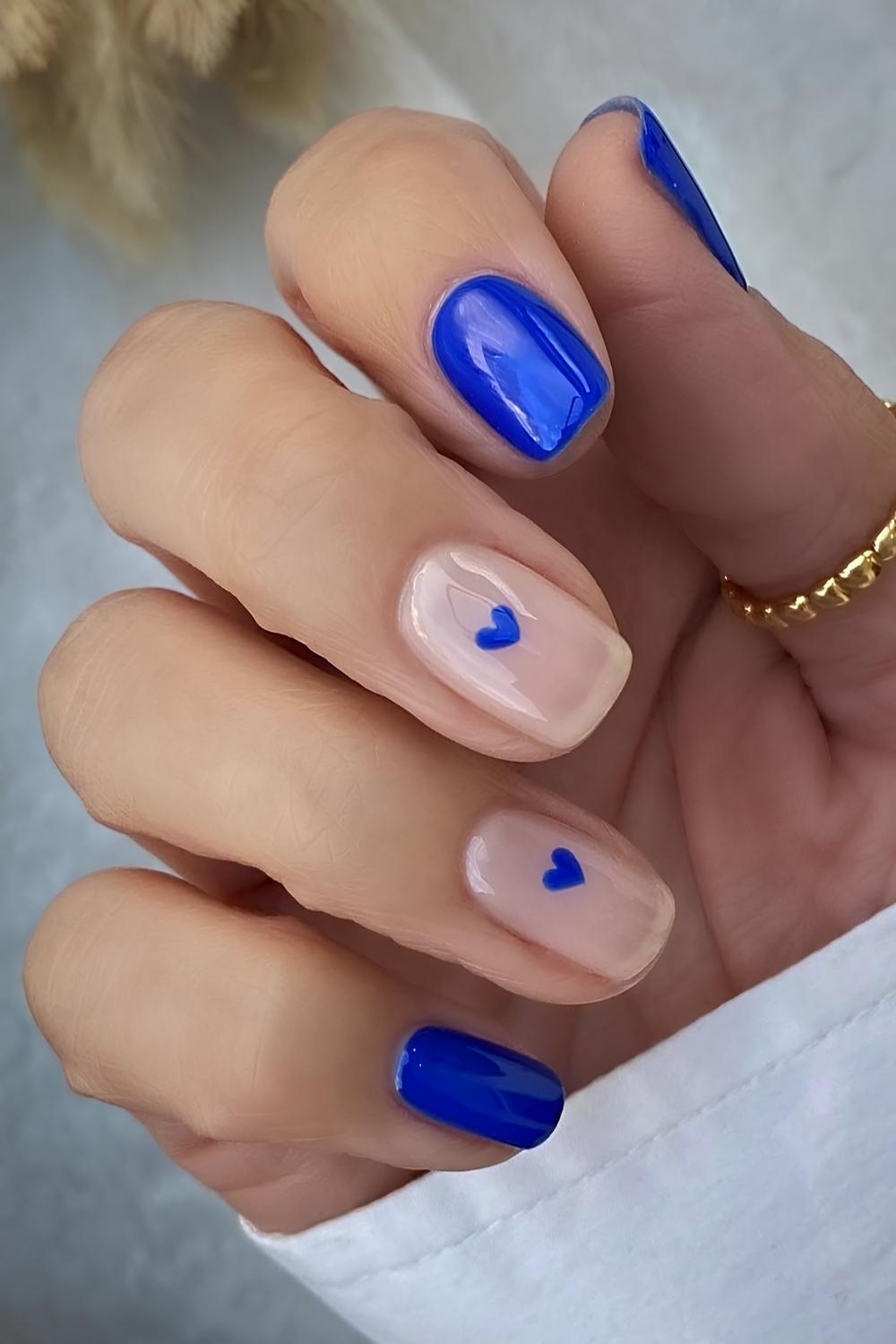 Vibrant blue nails with hearts