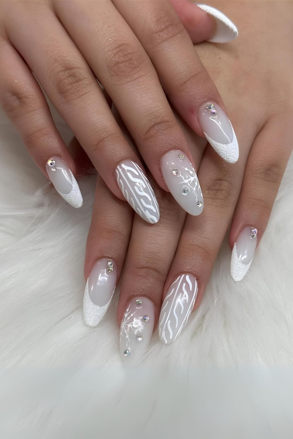 White nails with rhinestones and sweater pattern art