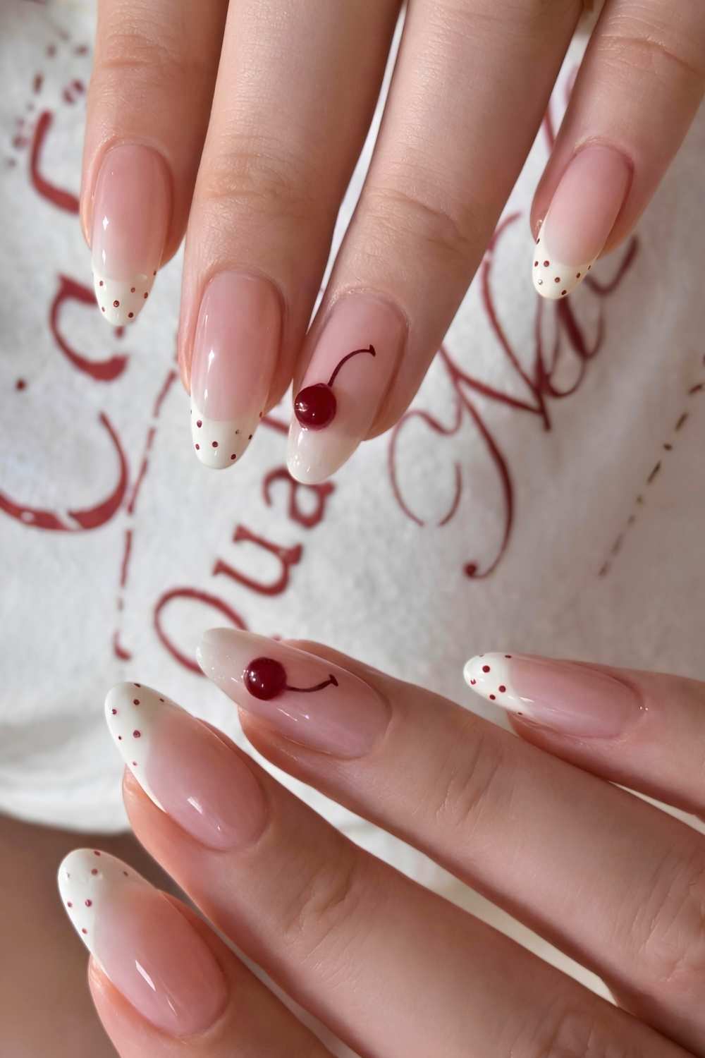 White French mani with red polka dots and cherries