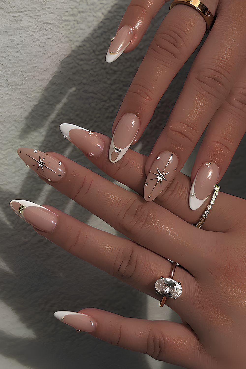 White French manicure with gold chrome stars