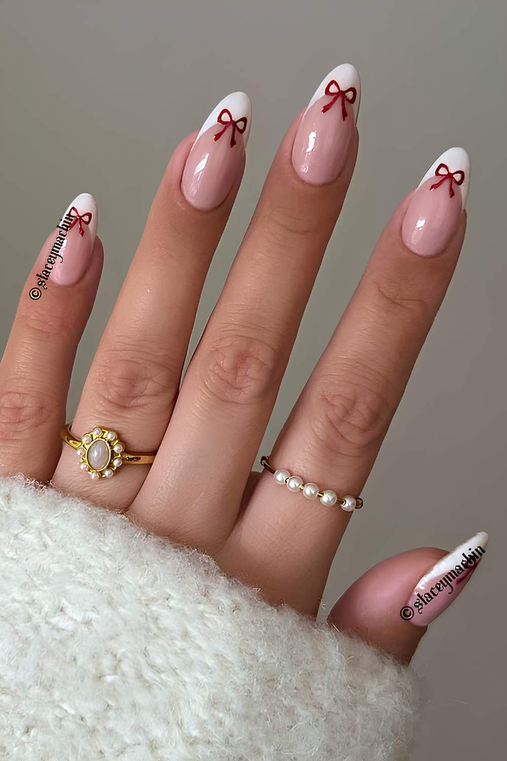 White French manicure with red bow art