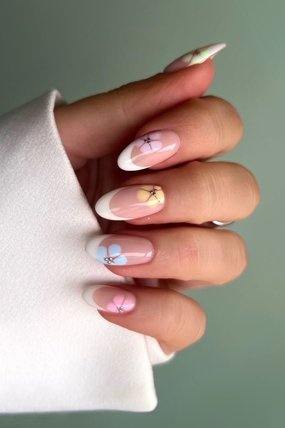 White French nails with pastel blooming flowers