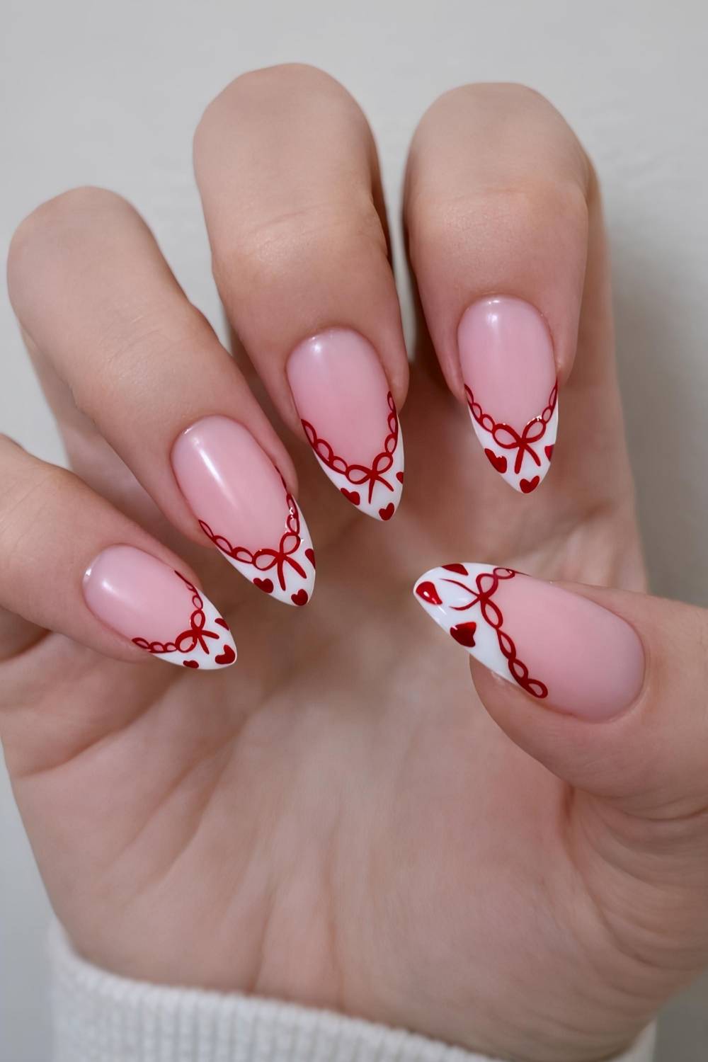 White French nails with red hearts and lace art