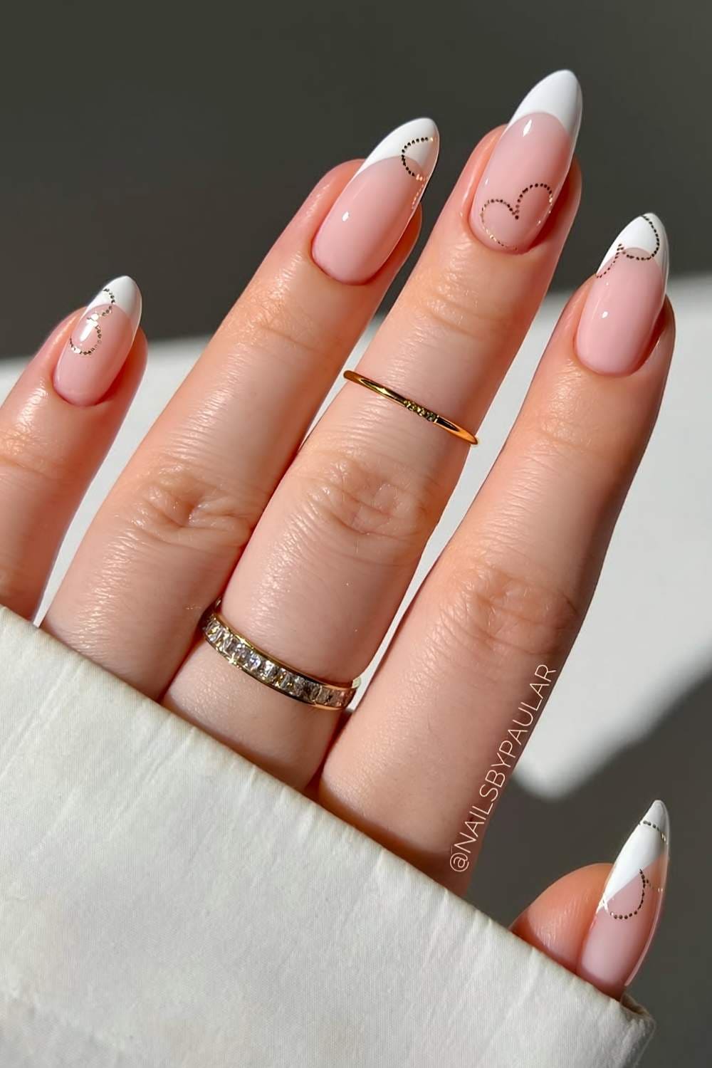 White French nails with sparkly heart outlines