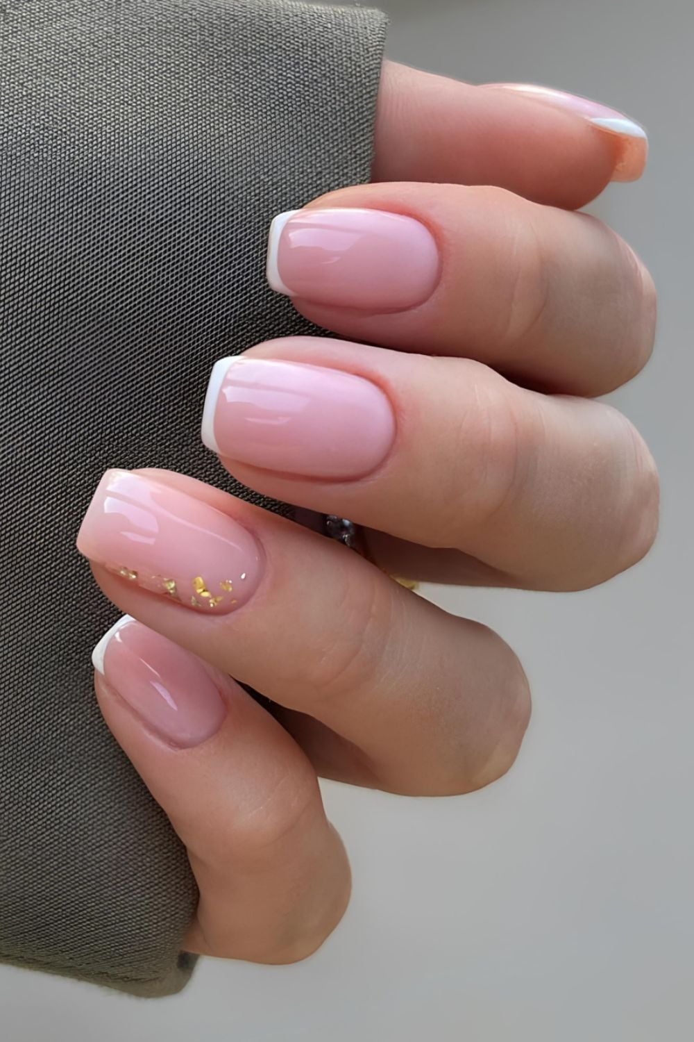 White French tip nails with gold foil accent
