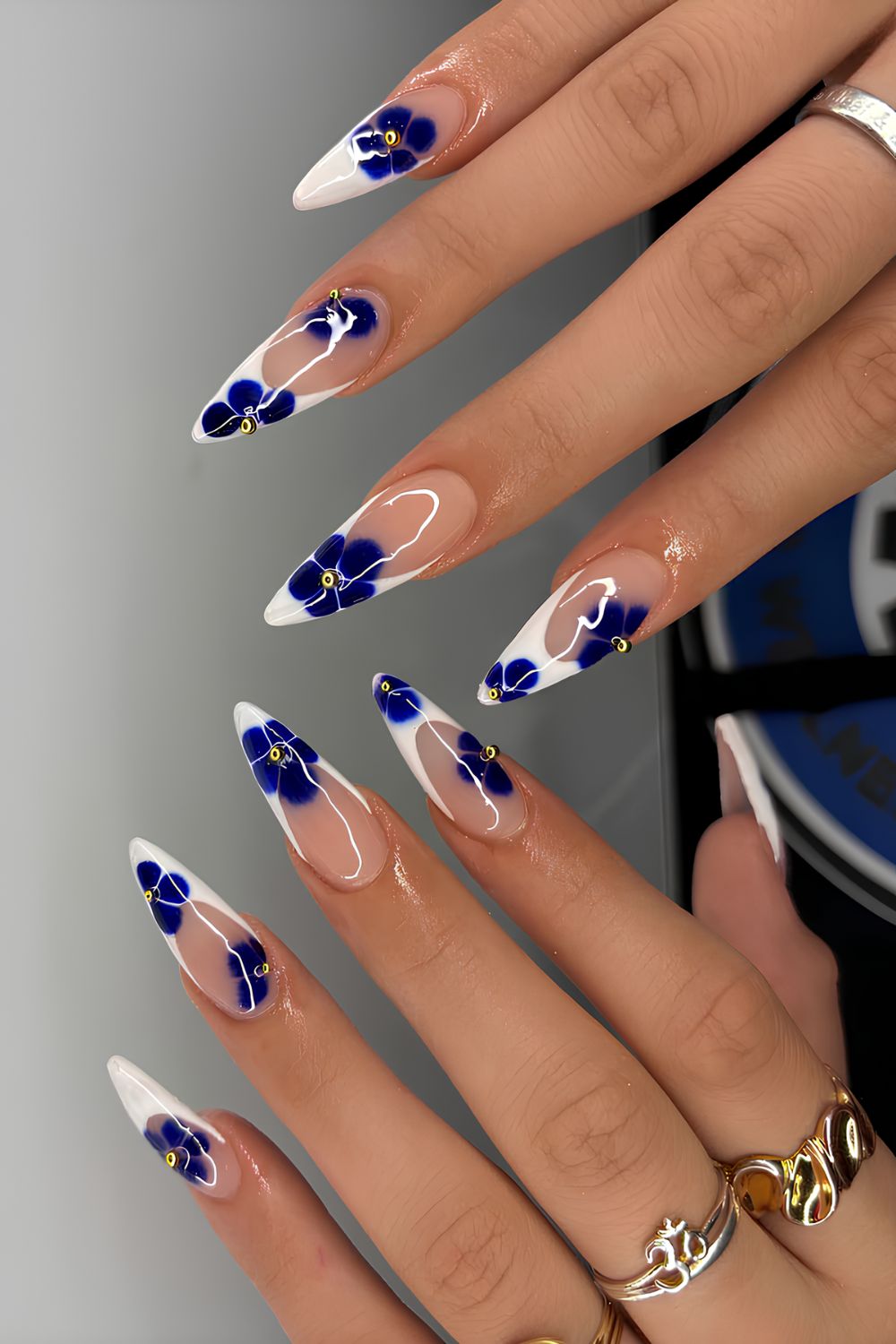 White French tips with navy blue blooming gel flower accents