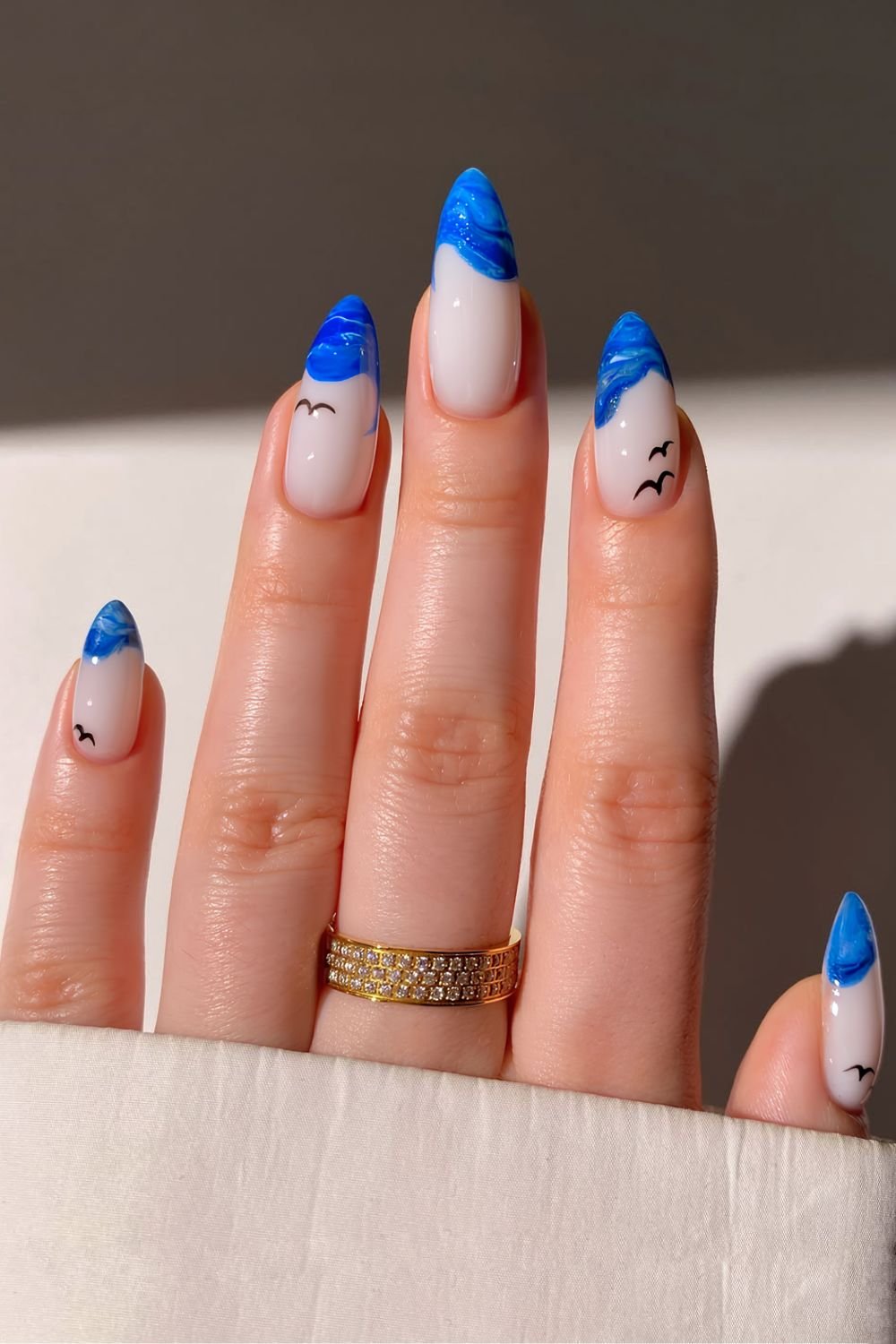 White base with with blue marble French tips and bird details