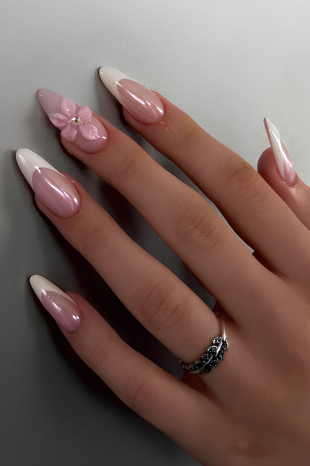 White chrome French nails with textured flowers