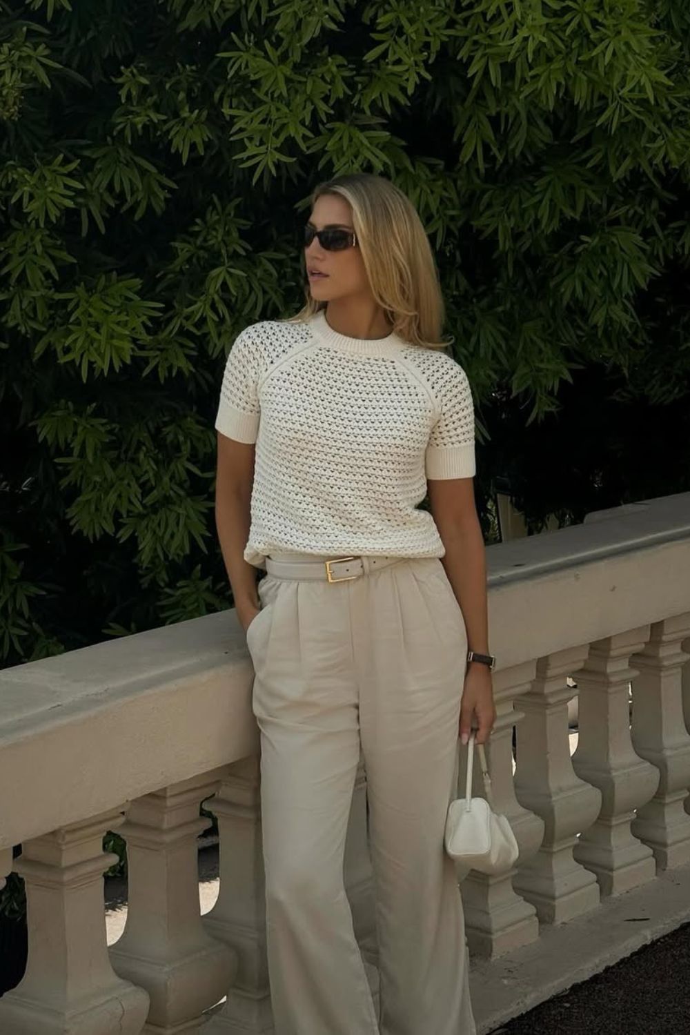 White crochet top with beige trousers