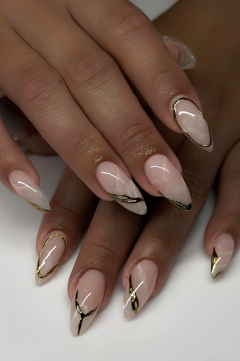 White marble nails with gold chrome details