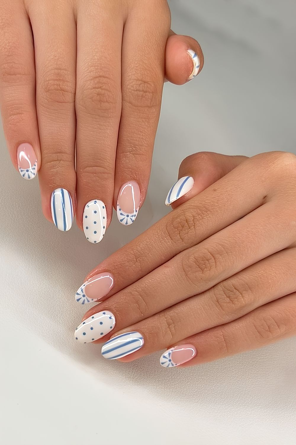 White nails with blue stripes and dots