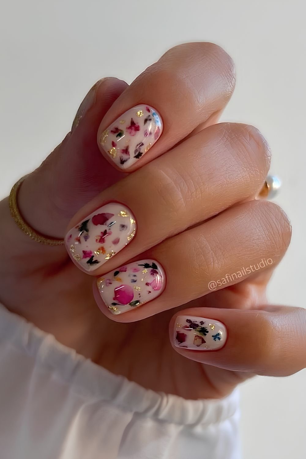 White nails with colorful floral nail art