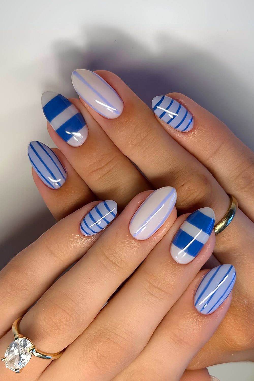 White nails with dark and light blue stripes