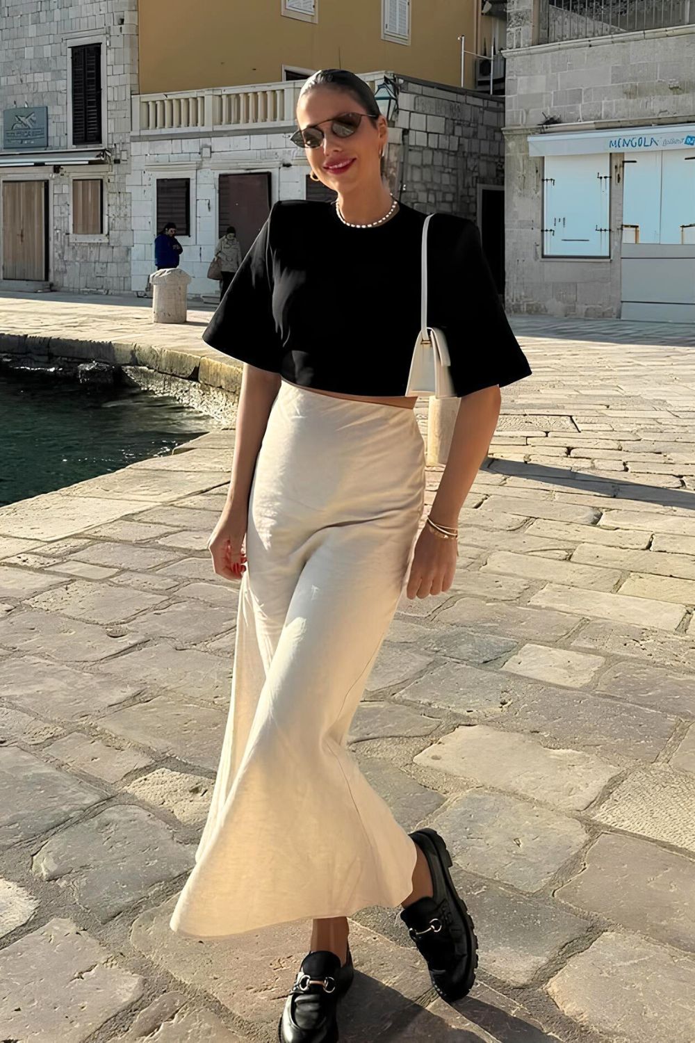 White silk skirt with black T-shirt and black loafers